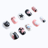 Pink and black press-on nails with playful cat faces and paw prints and sweet heart designs