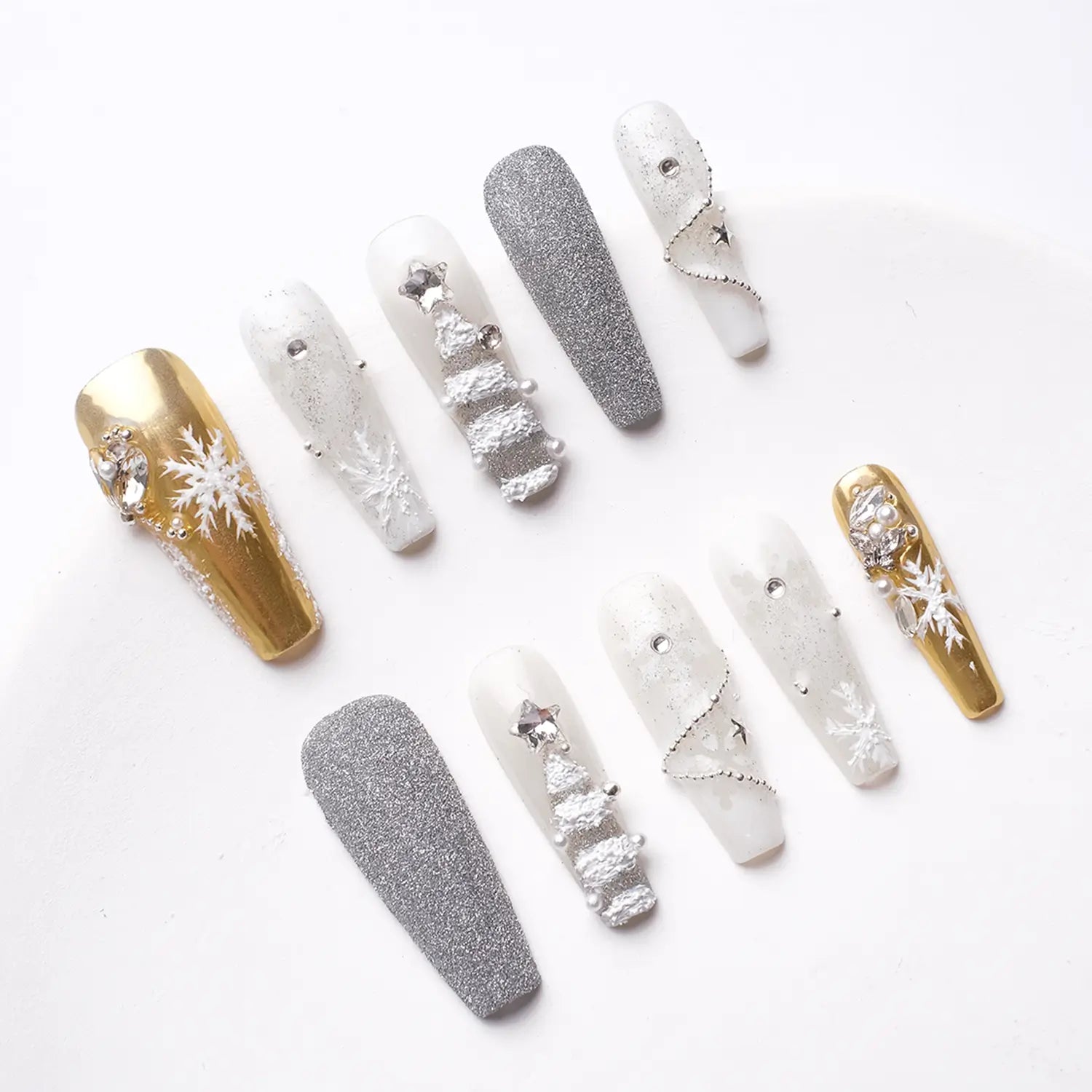 Close-up showing detailed, shiny nails with intricate jewellery and vibrant colors