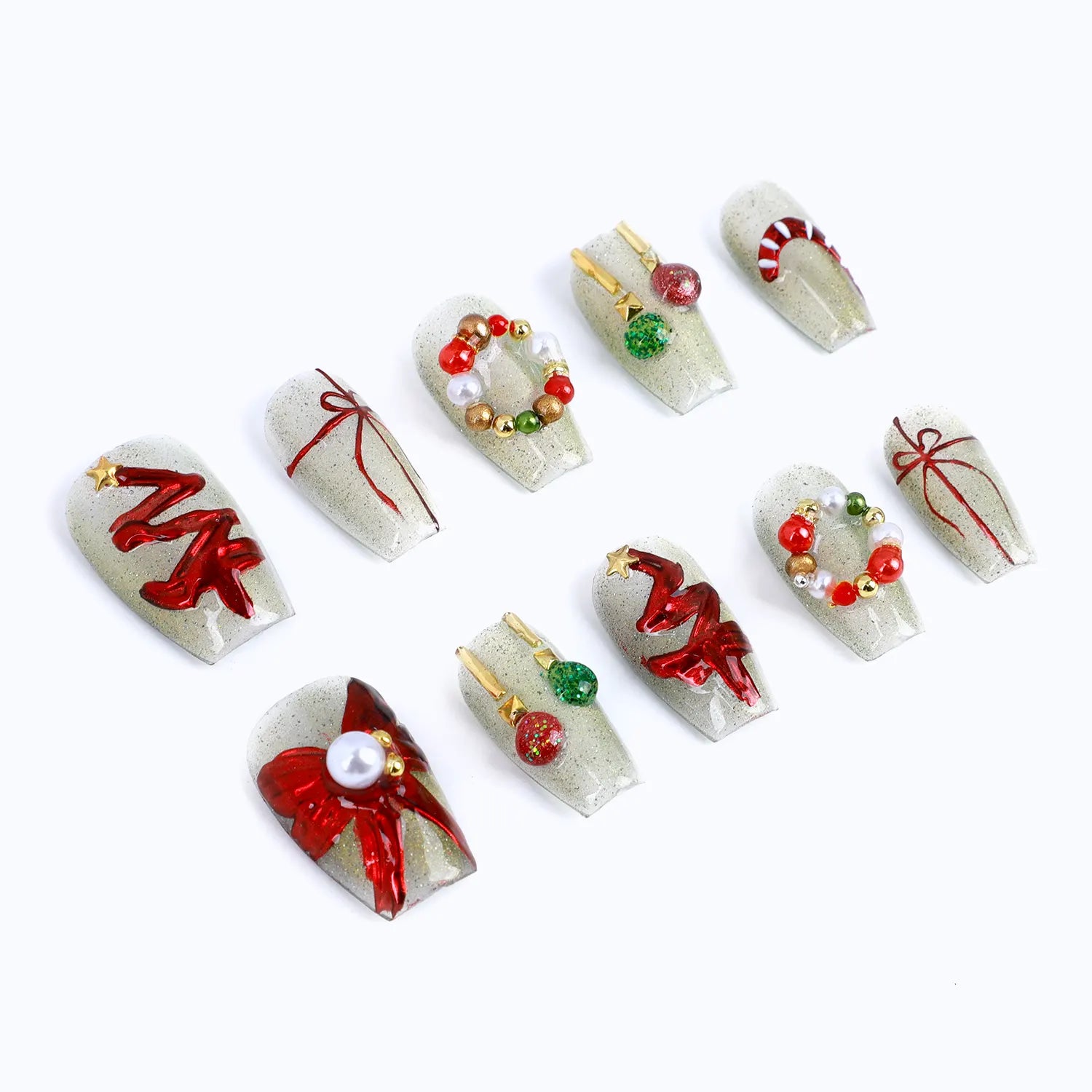 Christmas-themed false nails. The nails are coffin and have a shiny white base. Each nail is decorated with a different Christmas-themed pattern, including a Christmas tree, a wreath, a candy cane, and a bow. 