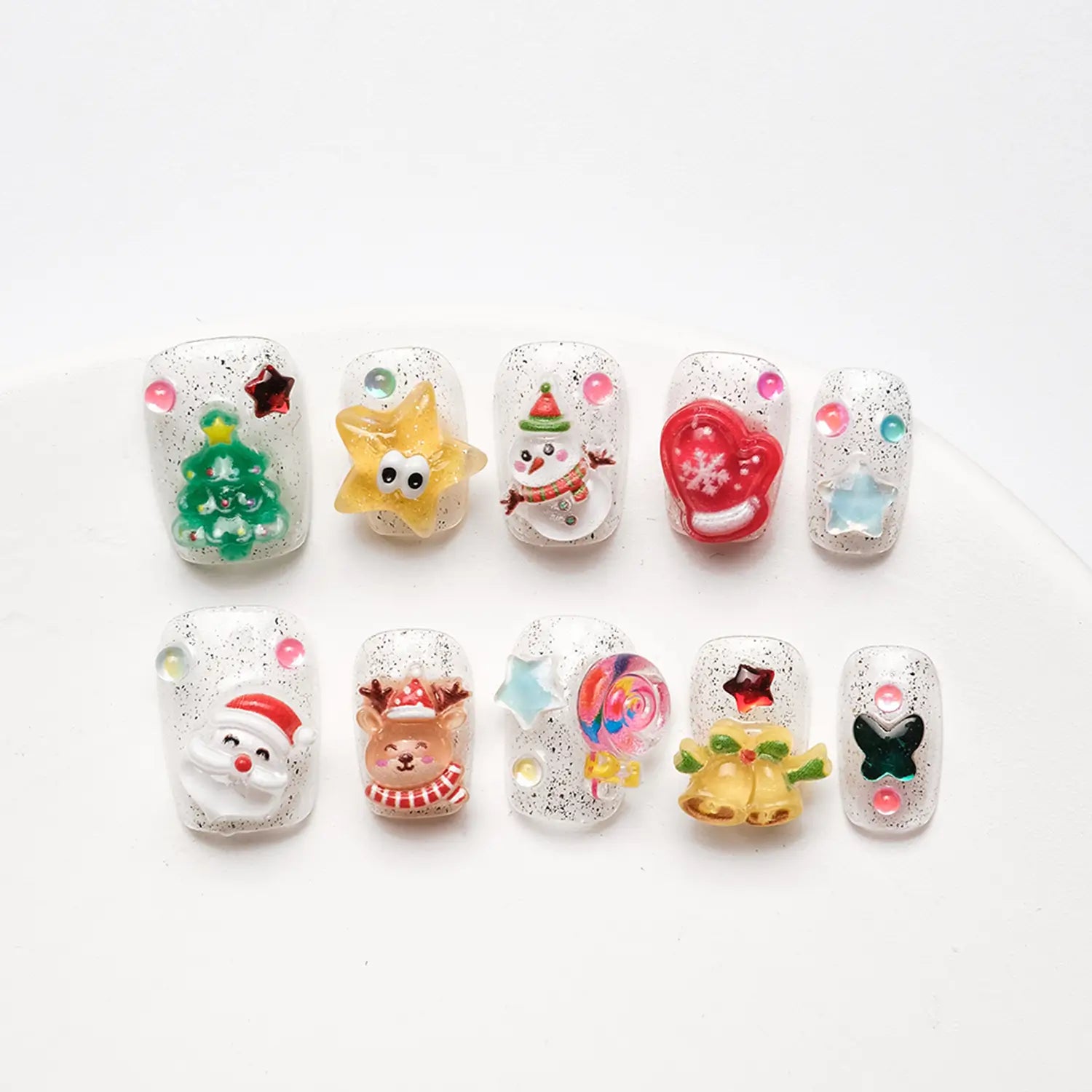 Close-up shot from the front showing detailed nail art, intricate 3D Christmas tree decorations and bright colors