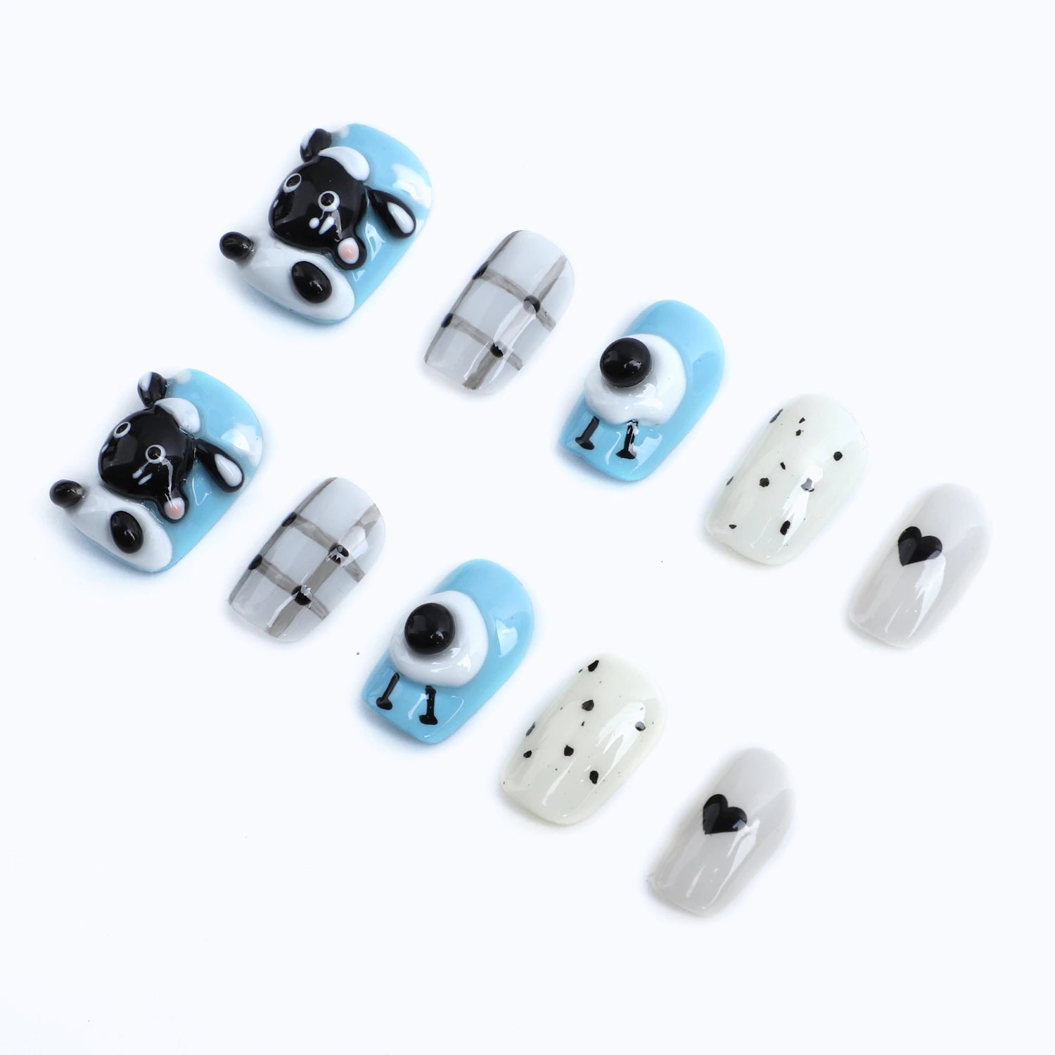 Pastel blue base with black and white accessories and press-on nails