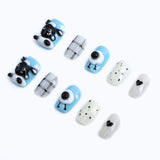 Pastel blue base with black and white accessories and press-on nails