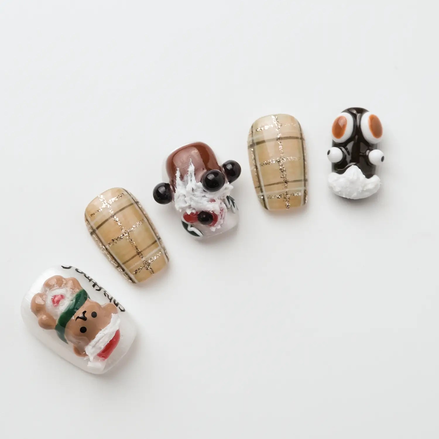 This is a Christmas nail. The nails are painted with a beige checkered pattern and each nail is decorated with a different Christmas themed decoration.