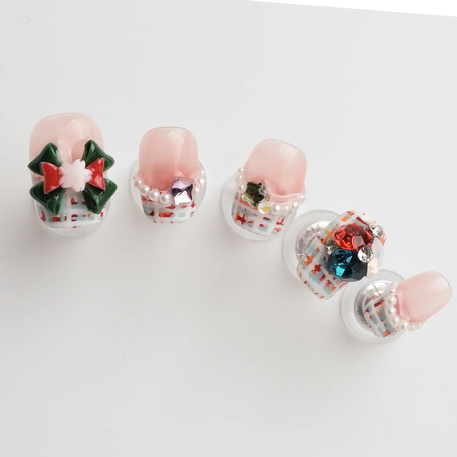 The nails are pink with a classic red and white checkered pattern