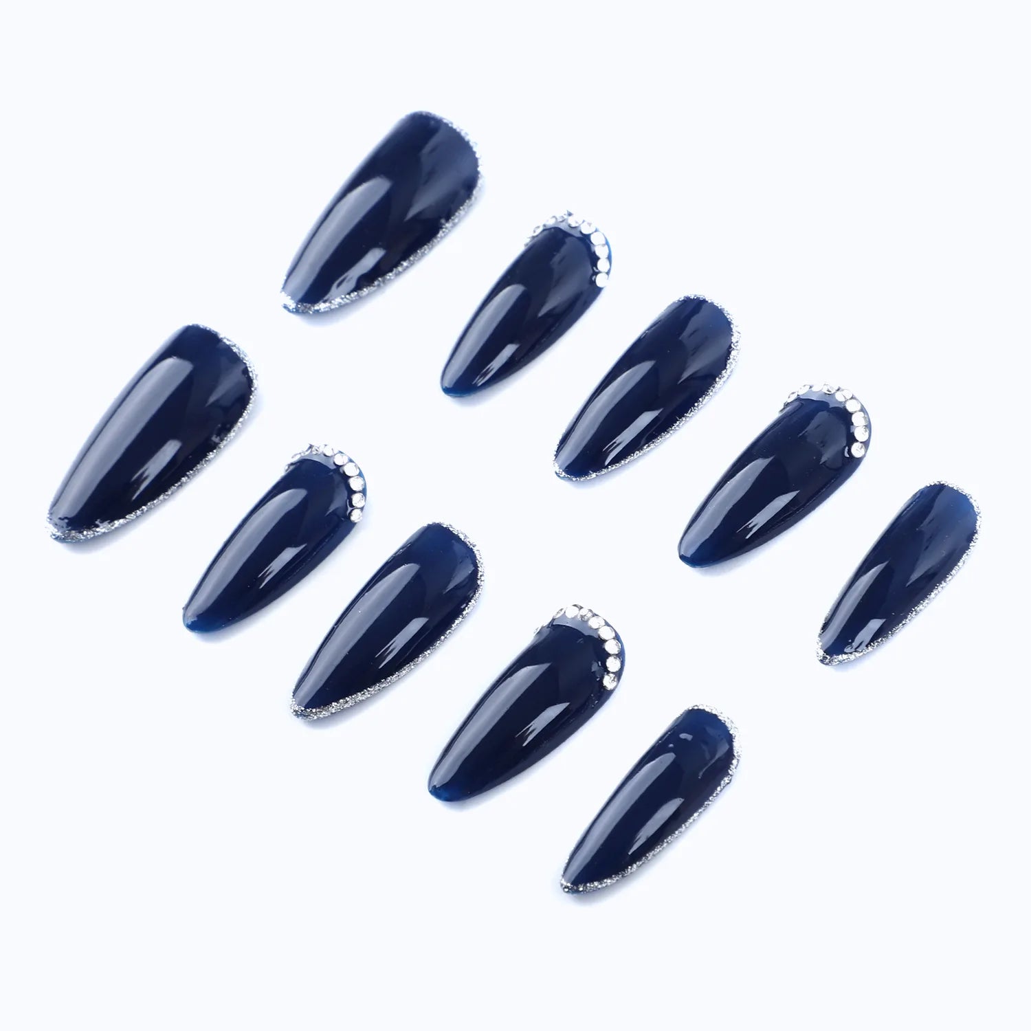 A deep blue almond-shaped press-on nail embellished with a line of sparkling rhinestones offers a classy and luxurious feel.