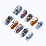 The nail ideas have two main base colors: one has a denim texture of blue, and the other is shiny orange. 