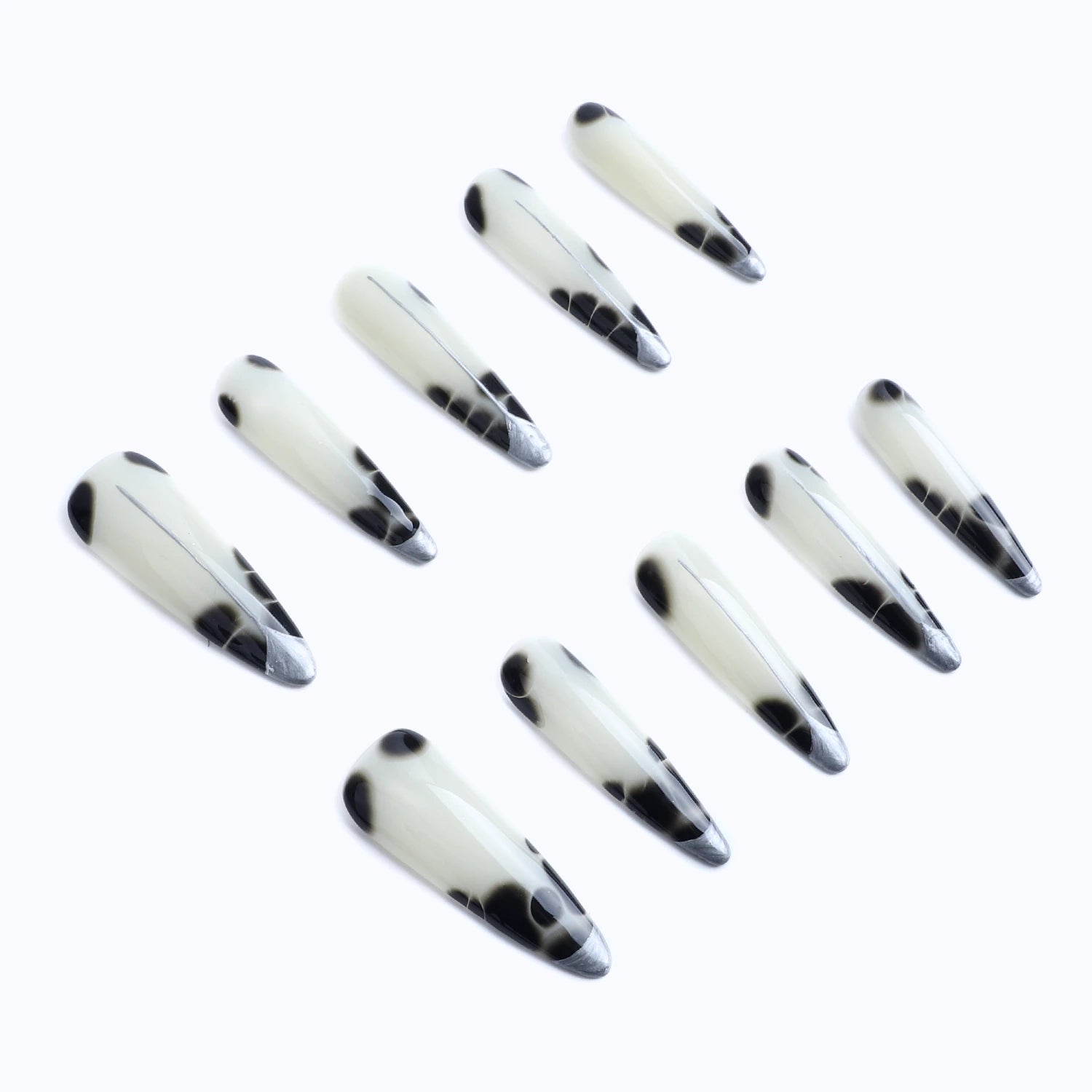 Create a bold and stylish look with these elegant black and white cow print stiletto press-on nails. 