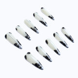 Create a bold and stylish look with these elegant black and white cow print stiletto press-on nails. 