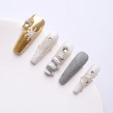 Press on nails are mainly gold, white and silver, dotted with snowflakes and Christmas tree shapes