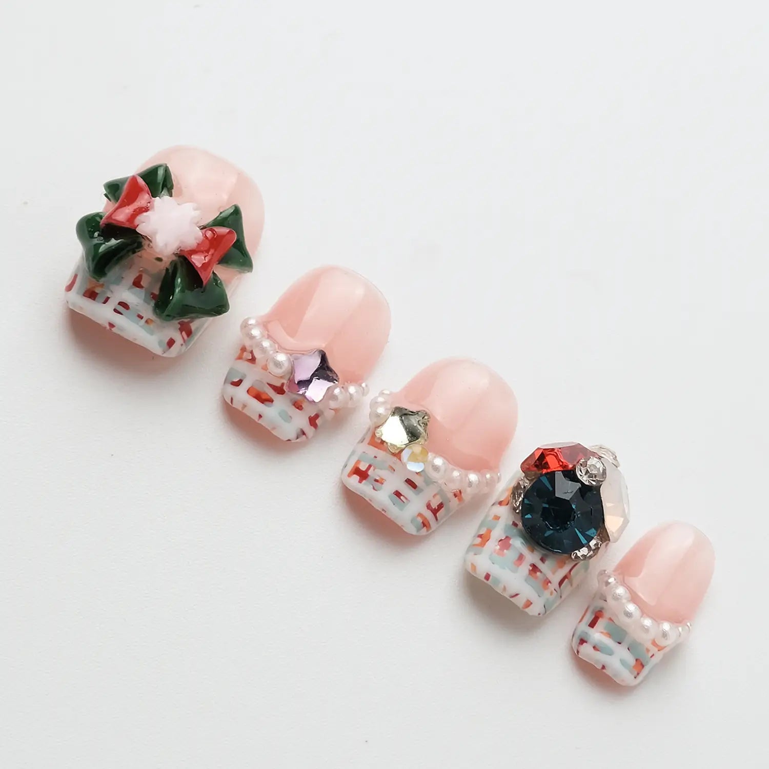 Nails embellished with 3D shiny pearls and gemstones