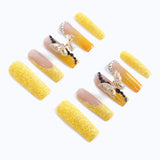 Press-on nails from the right side, highlighting the 3D butterfly and diamond design