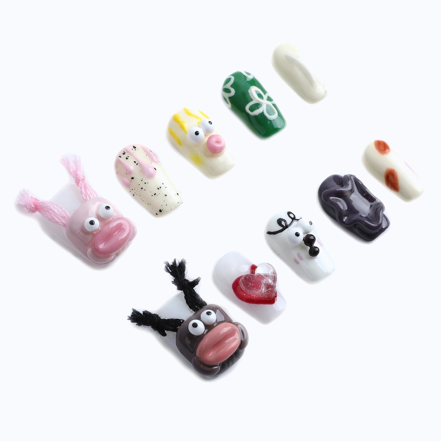 Press-on nails with pink bunny fur, funky hearts, and reindeer antler designs