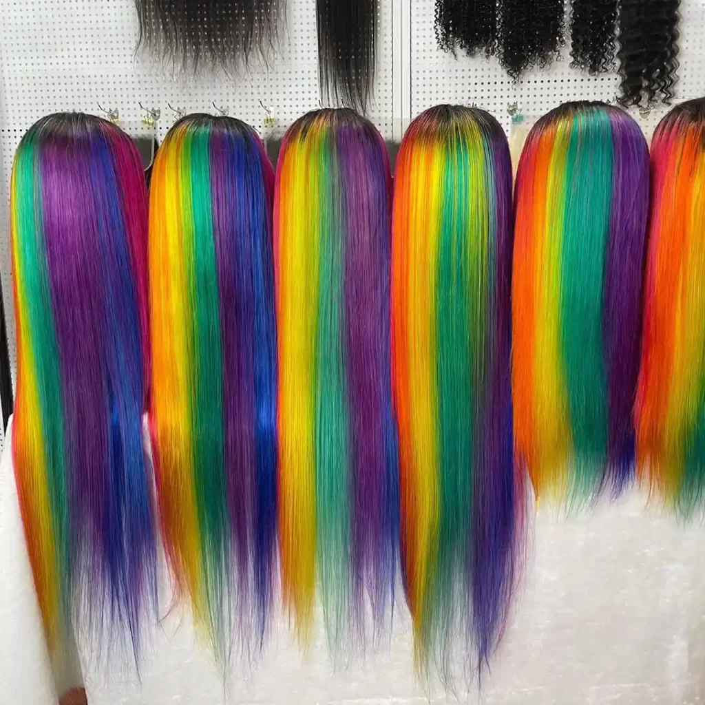 A row of rainbow colored 6a 7a 8a 9a 10a grade hair wigs.